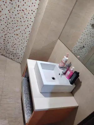 a bathroom with a white sink in a room at Regalia Suites in Kuala Lumpur