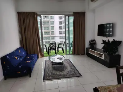 a living room with a couch and a glass table at Regalia Suites in Kuala Lumpur