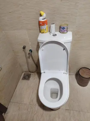 a bathroom with a white toilet in a stall at Regalia Suites in Kuala Lumpur