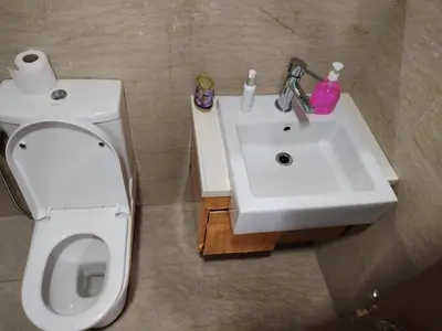 a bathroom with a white toilet and a sink at Regalia Suites in Kuala Lumpur