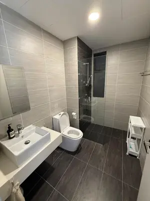 a bathroom with a white sink and a toilet at Trion Skyview Residence KL City Centre in Kuala Lumpur