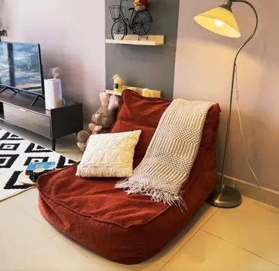 a brown couch with pillows on a living room at Trion Skyview Residence KL City Centre in Kuala Lumpur