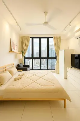 a bedroom with a large bed and a large window at Majestic Residence by Aranova Stay in Kuala Lumpur