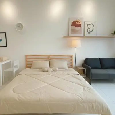 a bedroom with a large bed and a blue couch at Majestic Residence by Aranova Stay in Kuala Lumpur