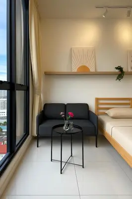 a room with a couch and a table with flowers on it at Majestic Residence by Aranova Stay in Kuala Lumpur