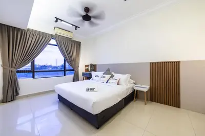 a bedroom with a bed and a large window at Royal Domain KL near Mont Kiara by Sleepy Bear in Kuala Lumpur