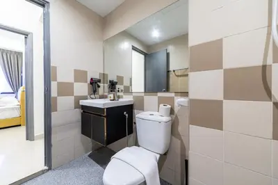a bathroom with a toilet and a sink at Royal Domain KL near Mont Kiara by Sleepy Bear in Kuala Lumpur