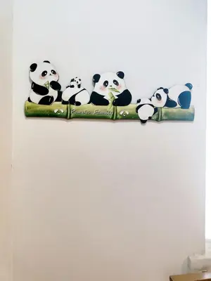 a group of stuffed pandas sitting on a pole at Suasana Bukit Ceylon with Panda Themes KL Tower View in Kuala Lumpur