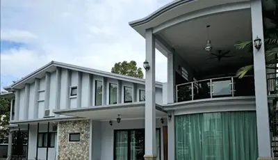 a large white house with a roof at Gasing WheelHouse in Petaling Jaya