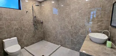 a bathroom with a shower and a toilet and a sink at Gasing WheelHouse in Petaling Jaya