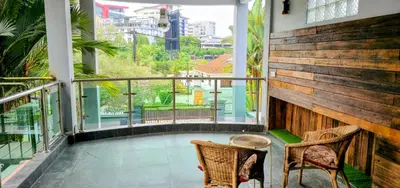 a balcony with two chairs and a view of a city at Gasing WheelHouse in Petaling Jaya