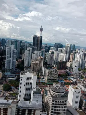 a view of a city with skyscrapers and the space needle at Afrin Service Suits at Berjaya Times Square in Kuala Lumpur