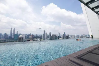 a pool on the roof of a building with a city at Regalia Studio apartment in Kuala Lumpur