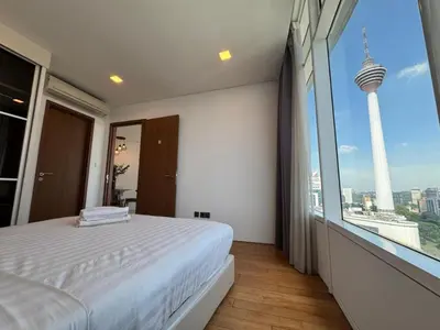a bedroom with a white bed and a large window at Vortex suites klcc by 2 bed 3 bed family suites vibes in Kuala Lumpur