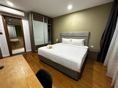 a bedroom with a large bed and a table at Vortex suites klcc by 2 bed 3 bed family suites vibes in Kuala Lumpur
