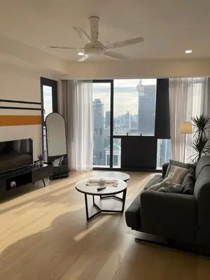 a living room with a couch and a table at Modern 1BR Apartment with KLCC Twin Towers View in Kuala Lumpur