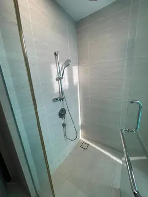 a shower with a glass door in a bathroom at Modern 1BR Apartment with KLCC Twin Towers View in Kuala Lumpur
