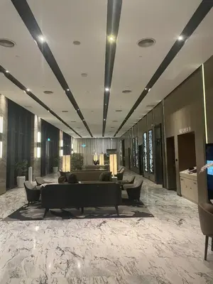 a lobby of a hotel with couches and chairs at Modern 1BR Apartment with KLCC Twin Towers View in Kuala Lumpur
