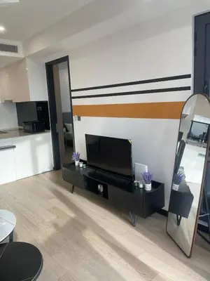 a living room with a television and a mirror at Modern 1BR Apartment with KLCC Twin Towers View in Kuala Lumpur