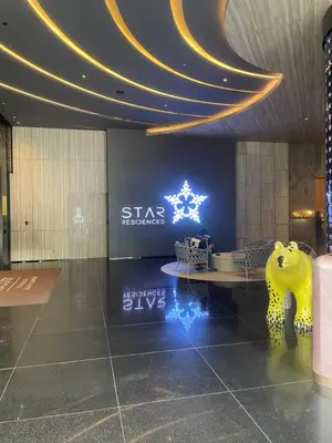 a room with a table and a sign in a building at Modern 1BR Apartment with KLCC Twin Towers View in Kuala Lumpur
