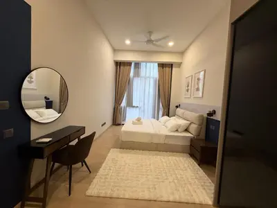 a bedroom with a bed and a mirror and a desk at Star Residance KLCC by Nexus in Kuala Lumpur