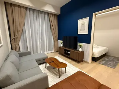 a living room with a couch and a television at Star Residance KLCC by Nexus in Kuala Lumpur