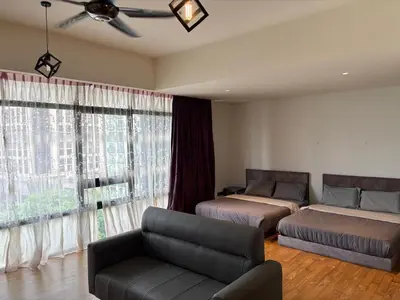 a living room with two beds and a couch at Anggun Residence KLCC by Airhost in Kuala Lumpur