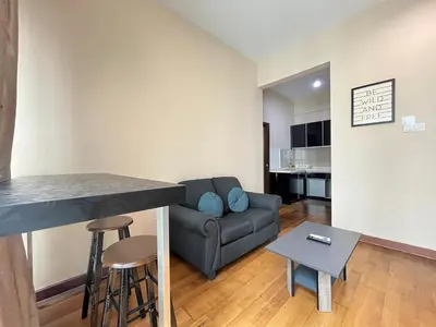 a living room with a couch and a table at Homestay Walking Distance to PWTC in Kuala Lumpur