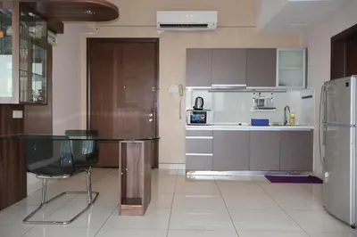 a kitchen with a glass table and a refrigerator at Homestay Walking Distance to PWTC in Kuala Lumpur