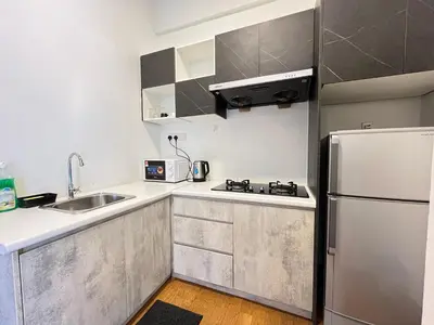 a small kitchen with a refrigerator and a sink at Homestay Walking Distance to PWTC in Kuala Lumpur