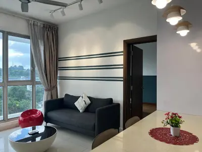 a living room with a blue couch and a table at Homestay Walking Distance to PWTC in Kuala Lumpur
