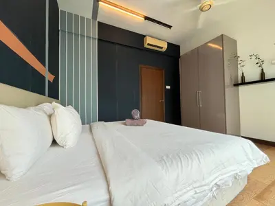 a large white bed with a stuffed animal sitting on it at Homestay Walking Distance to PWTC in Kuala Lumpur