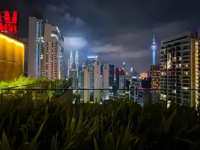 a view of a city skyline at night at Majestic Residence Infinity Pool with KLCC View in Kuala Lumpur