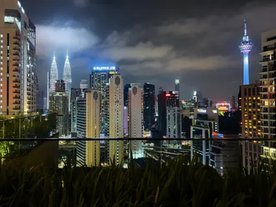 a view of a city skyline at night at Majestic Residence Infinity Pool with KLCC View in Kuala Lumpur
