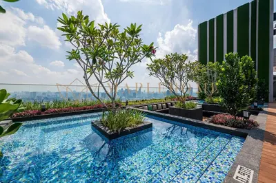 a swimming pool with trees on top of a building at Delightful Studio Suite in Kuala Lumpur