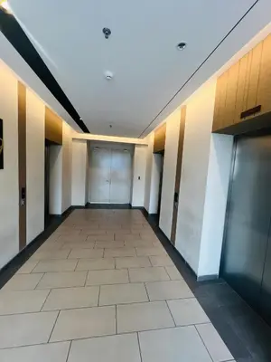 an empty hallway of a building with doors and a tile floor at Axon Suite near Pavilion KL by Sky in Kuala Lumpur