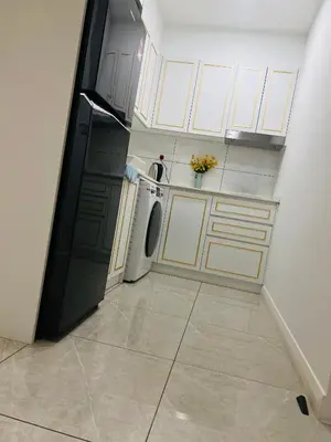 a kitchen with a black refrigerator and a dishwasher at Axon Suite near Pavilion KL by Sky in Kuala Lumpur