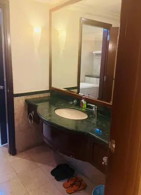 a bathroom with a sink and a large mirror at Times Square Service Suites By Humira in Kuala Lumpur