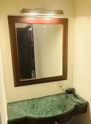 a mirror on a wall above a sink in a bathroom at Times Square Service Suites By Humira in Kuala Lumpur