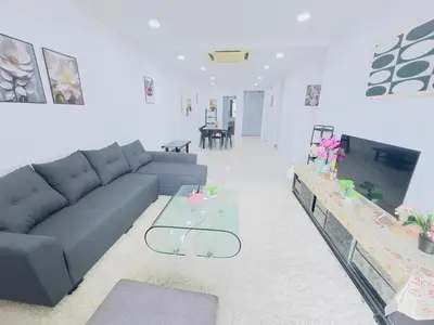 a living room with a couch and a table at STANDARD HOME Taragon Puteri Bintang in Kuala Lumpur