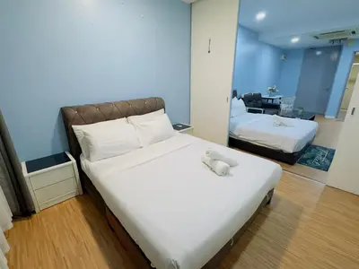 a bedroom with a bed with a teddy bear on it at STANDARD HOME Taragon Puteri Bintang in Kuala Lumpur