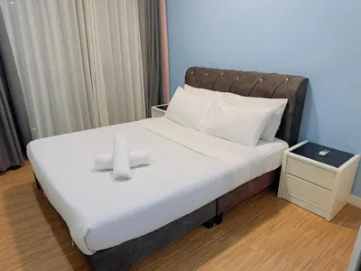 a bed with a stuffed animal on top of it at STANDARD HOME Taragon Puteri Bintang in Kuala Lumpur