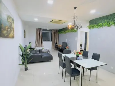 a living room with a table and a couch at STANDARD HOME Taragon Puteri Bintang in Kuala Lumpur