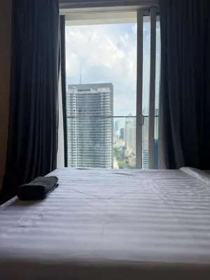 a bedroom with a bed and a large window at Quill Residence by Infinity pool in Kuala Lumpur