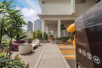 a building with chairs and plants on a balcony at Quill Residence by Infinity pool in Kuala Lumpur