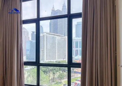 a view of a city skyline from a window at 188 Suites KLCC by VastHaven in Kuala Lumpur