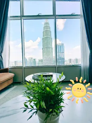 a room with a large window with a view of a city at Sky Suites KLCC by Global Family Suites in Kuala Lumpur