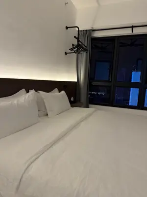 a large white bed in a room with a window at \u5409\u9686\u5761\u96c5\u5c45\u4e50\u5929\u6c47Agile\u56db\u6708\u516c\u5bd3 in Kuala Lumpur