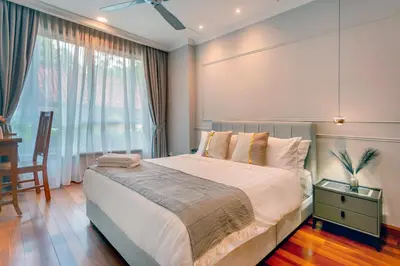 a bedroom with a large bed and a window at 325 Ritchie by COBNB at Ampang in Kuala Lumpur