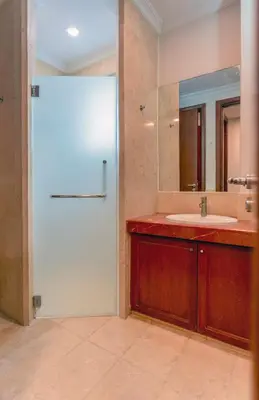 a bathroom with a white door and a sink at 325 Ritchie by COBNB at Ampang in Kuala Lumpur